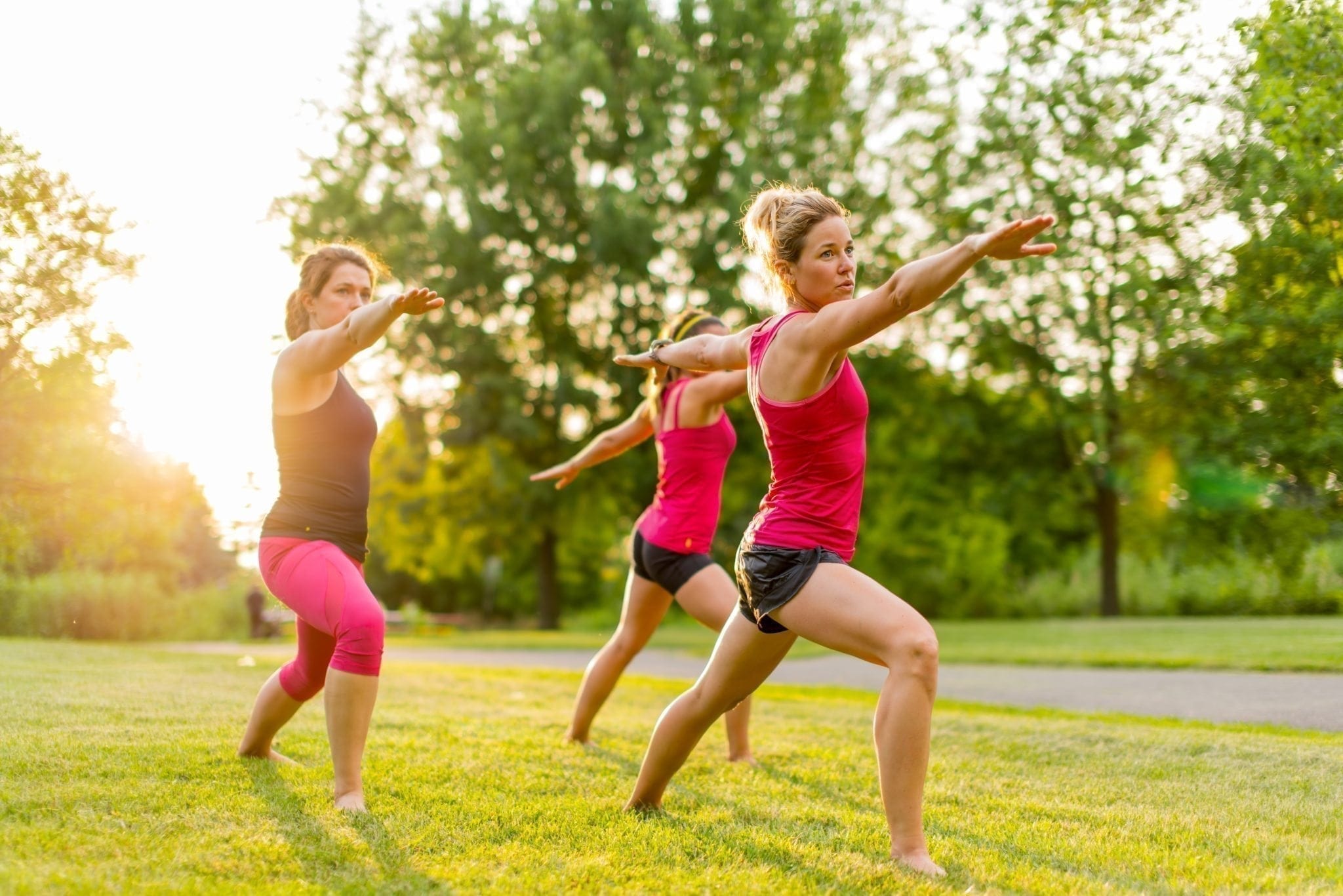 women doing yoga in grass